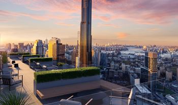 a rooftop terrace with a view of the city and a sunset at The Paxton, Brooklyn, NY 11201